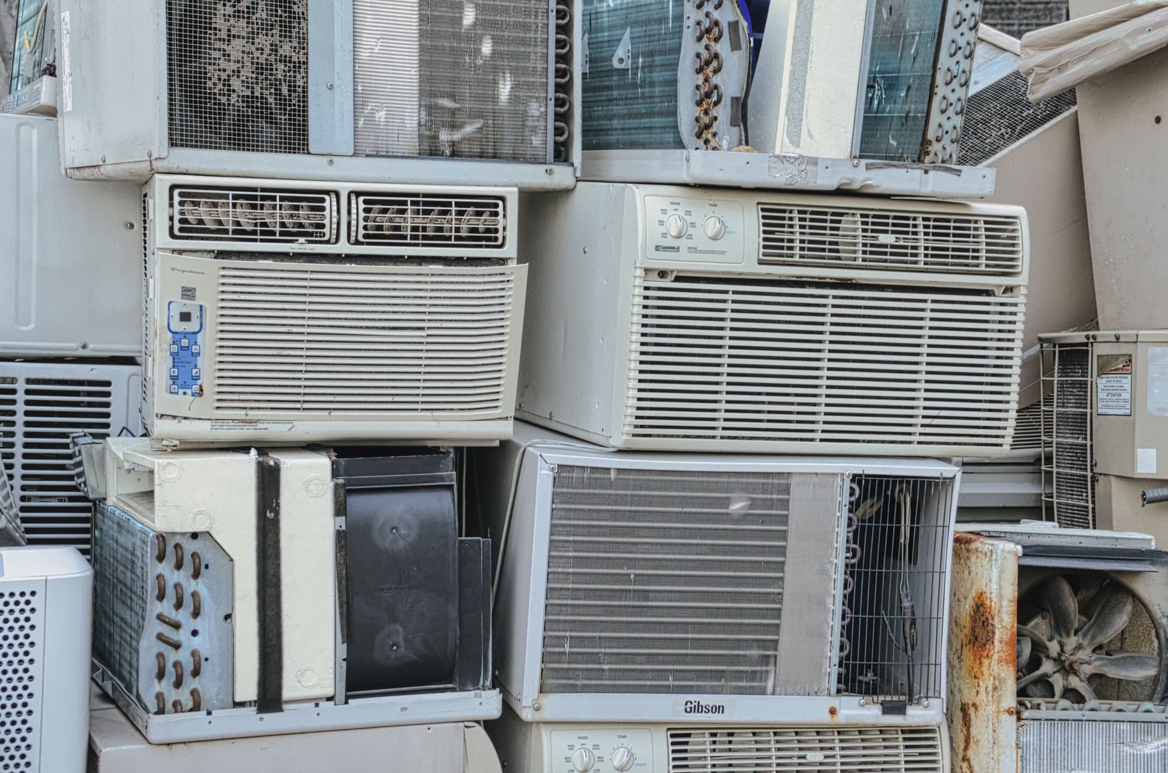 A stack of old window air conditioners waiting to be recycled