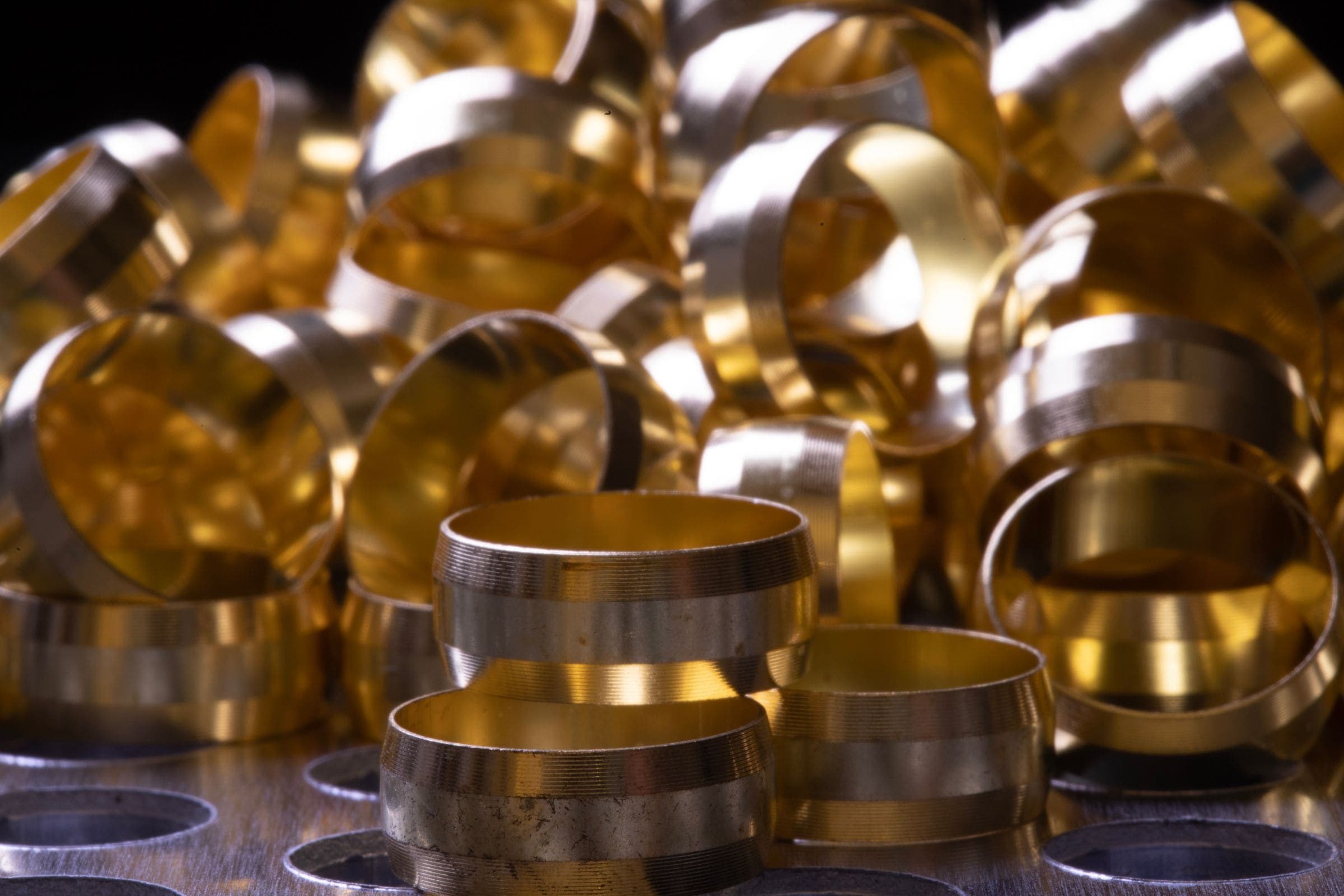 A heap of shiny brass plumbing compression olives