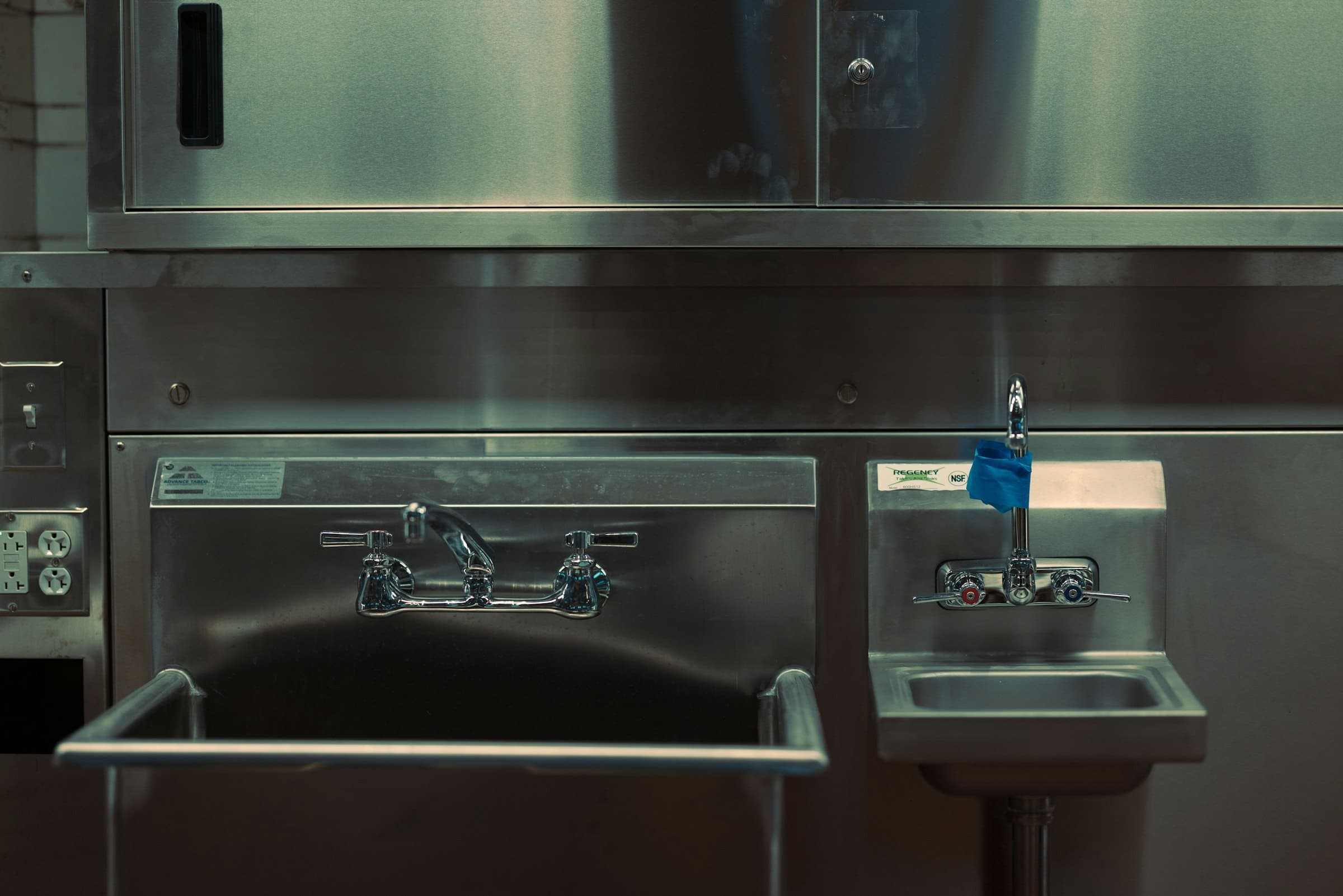 Stainless steel commercial kitchen sinks, splashback and benches