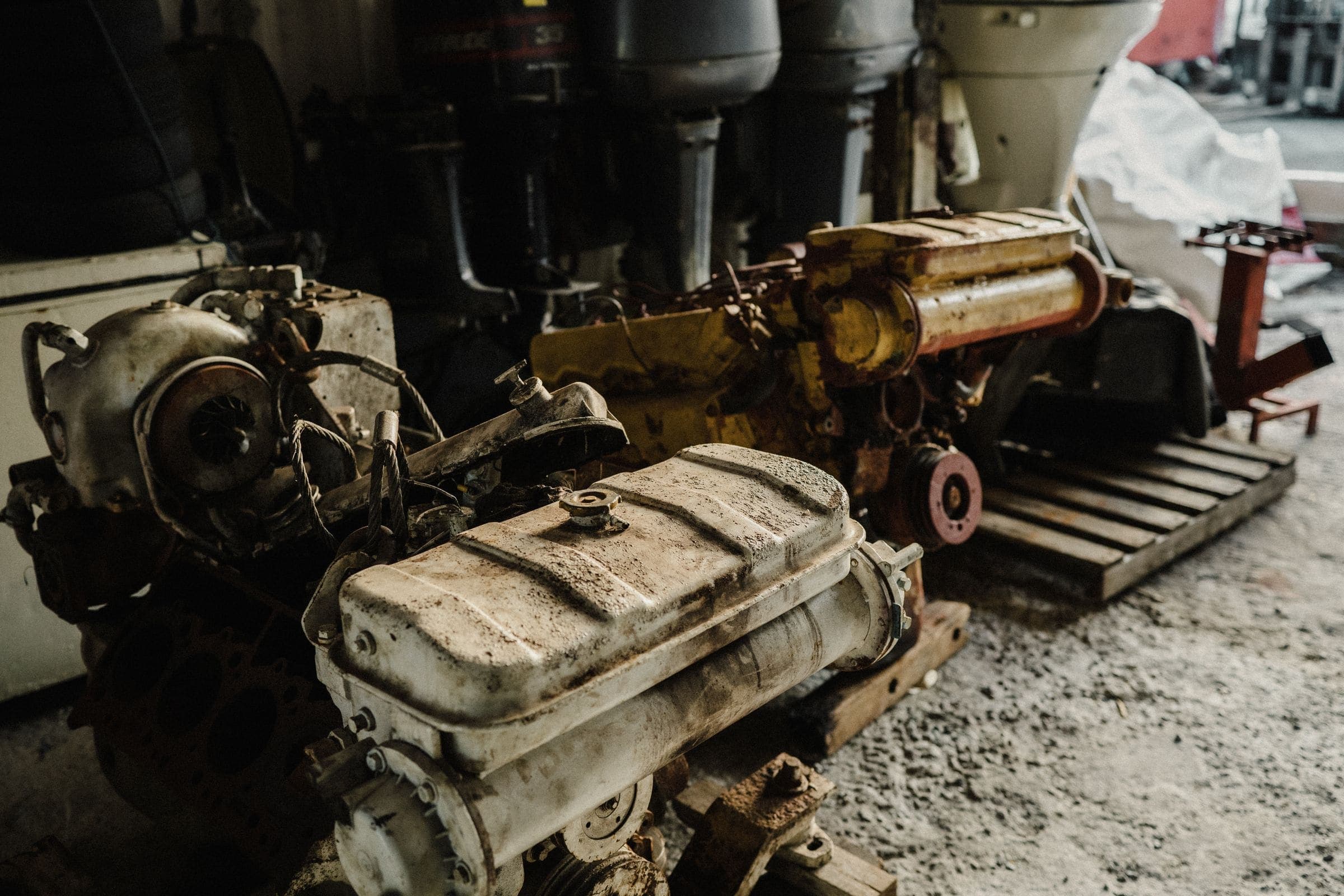 Used car engines Several dirty used car engines on a workshop floor