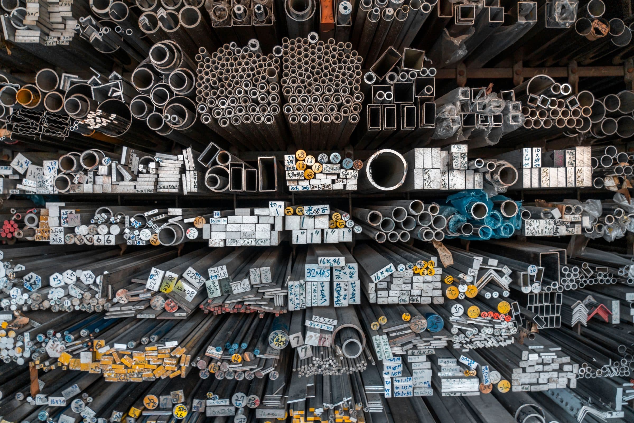 Racks of metal tube, box section, angle and bar, seen end-on Racks of metal tube, box section, angle and bar, seen end-on