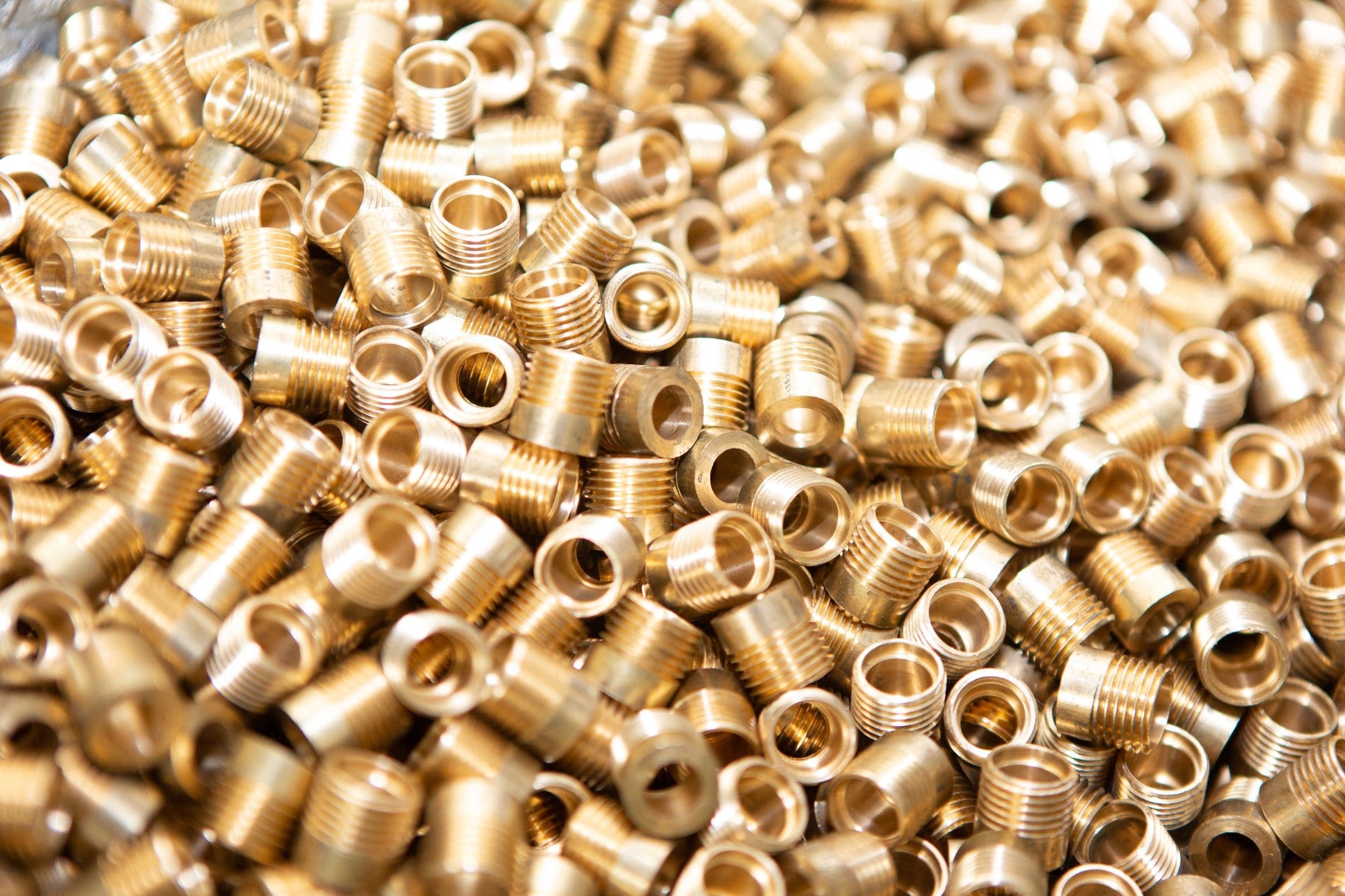 A pile of brass screws and nuts A pile of brass screws and nuts