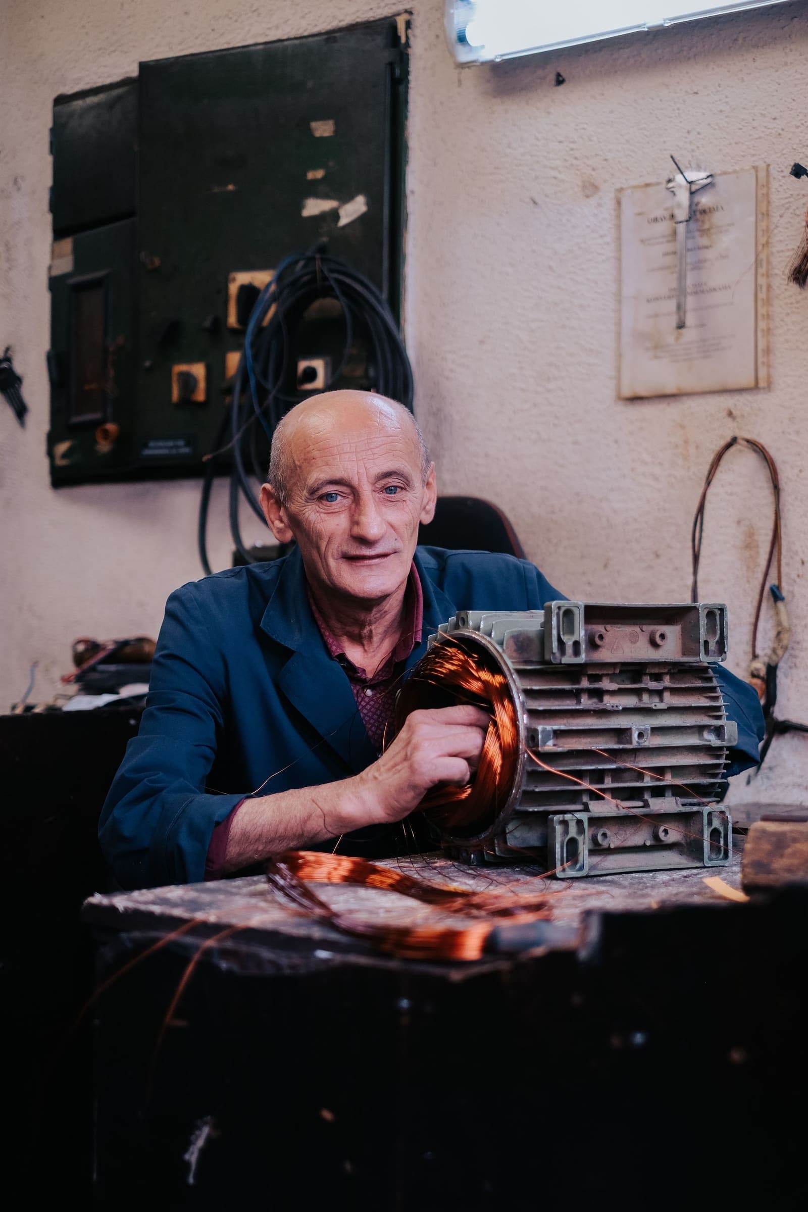 Alternator on the workbench A mechanic at a workshop bench working on a car alternator
