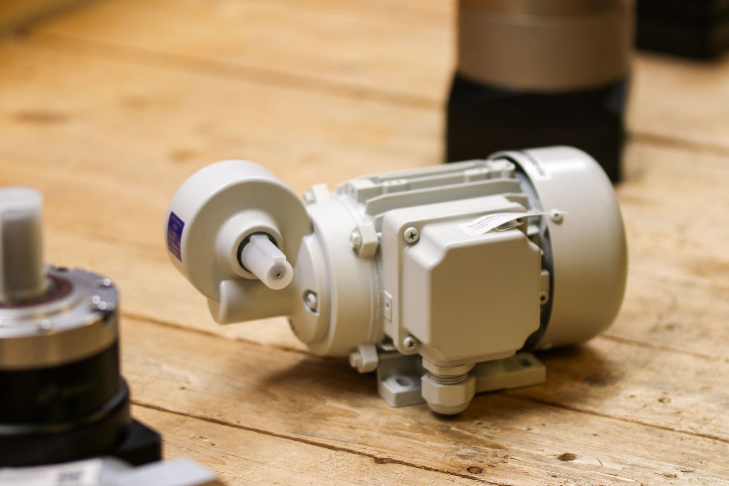Industrial electric motor A grey industrial electric gear motor on a wooden workbench