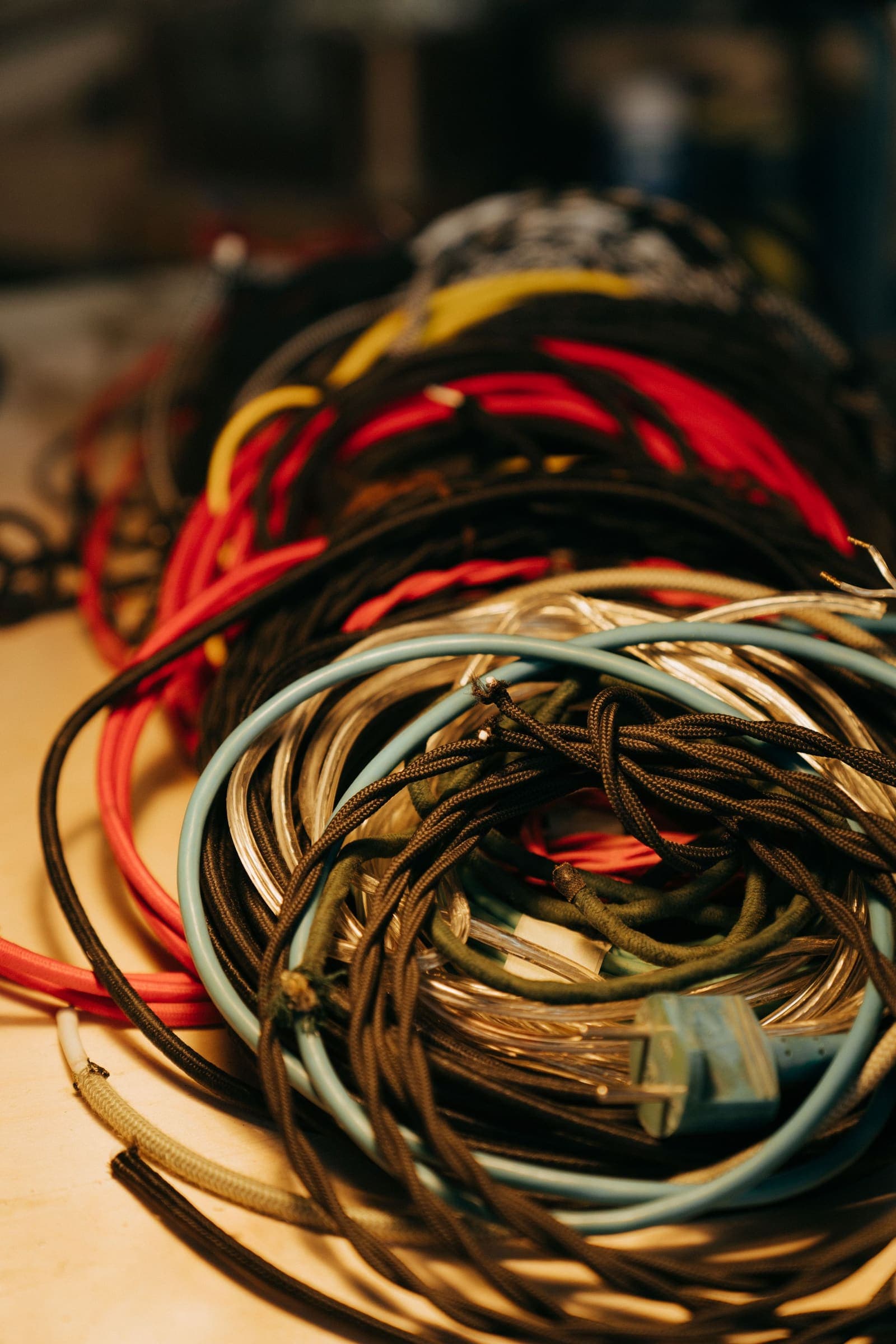 Coloured insulated wire Loose coils of red, yellow, grey and black insulated wire on a bench